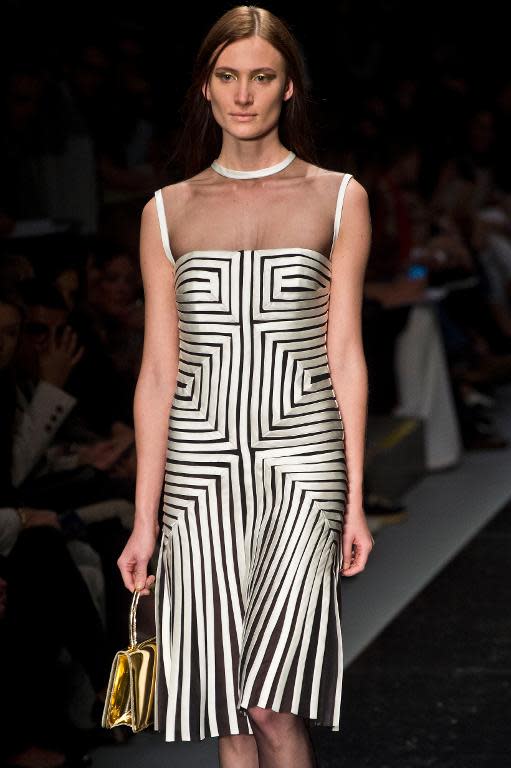 A model presents a creation by Reinaldo Lourenco during the 2014 Winter collections of the Sao Paulo Fashion Week in Sao Paulo, Brazil, on November 1, 2013