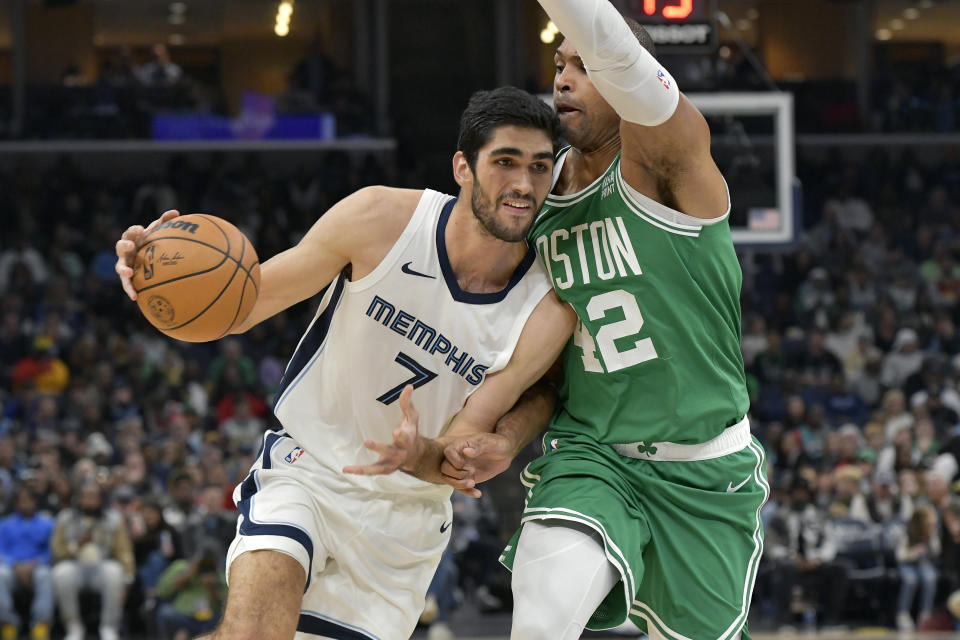 Memphis Grizzlies forward Santi Aldama (7) drives against Boston Celtics center Al Horford (42) in the first half of an NBA basketball game Sunday, Nov. 19, 2023, in Memphis, Tenn. (AP Photo/Brandon Dill)