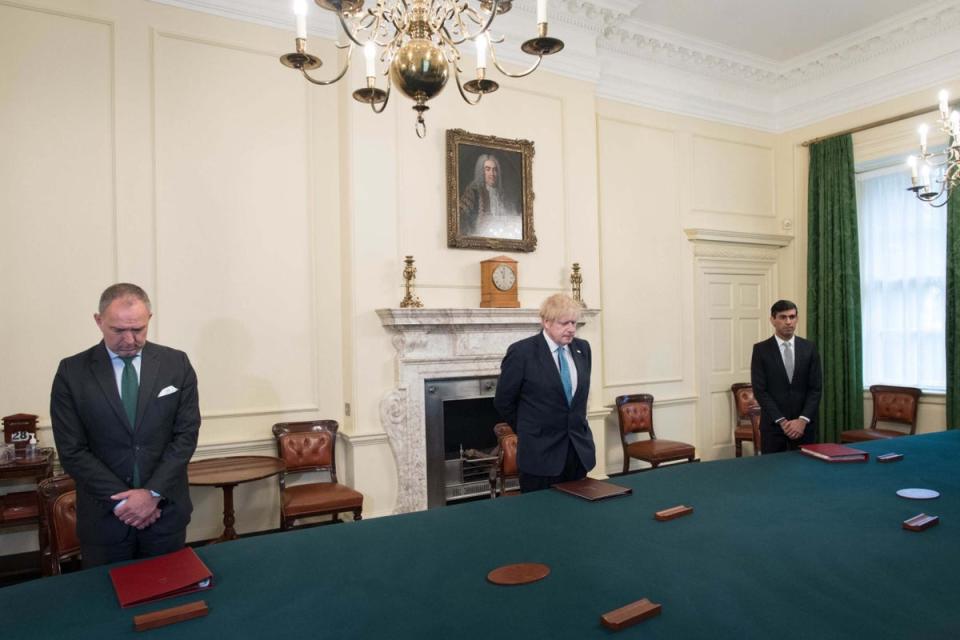 Sir Mark Sedwill, Boris Johnson and Chancellor Rishi Sunak stand inside the Cabinet Room of 10 Downing Street