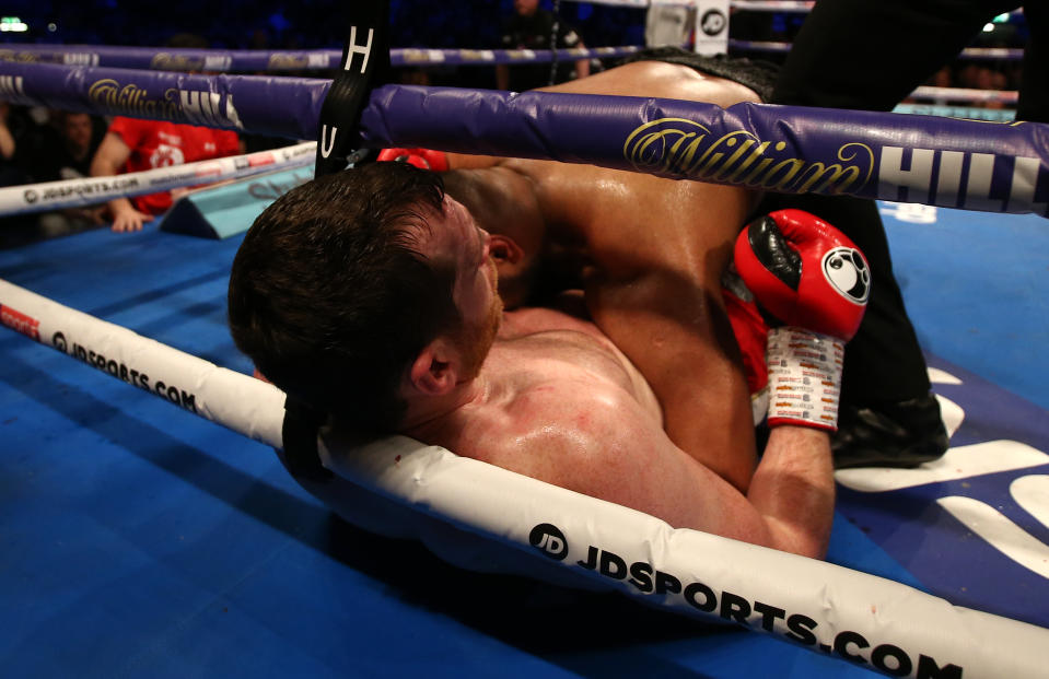 Kash Ali bites opponent David Price during their heavyweight boxing match (Getty)