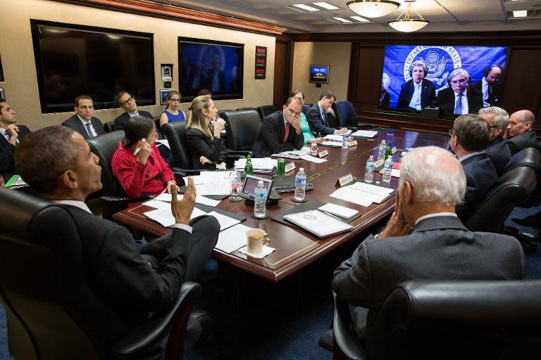 This official White House photograph shows President Barack Obama (L), Vice President Joe Biden (R) and members of the national security team participating in a secure video teleconference on March 31, 2015 in Washington, DC