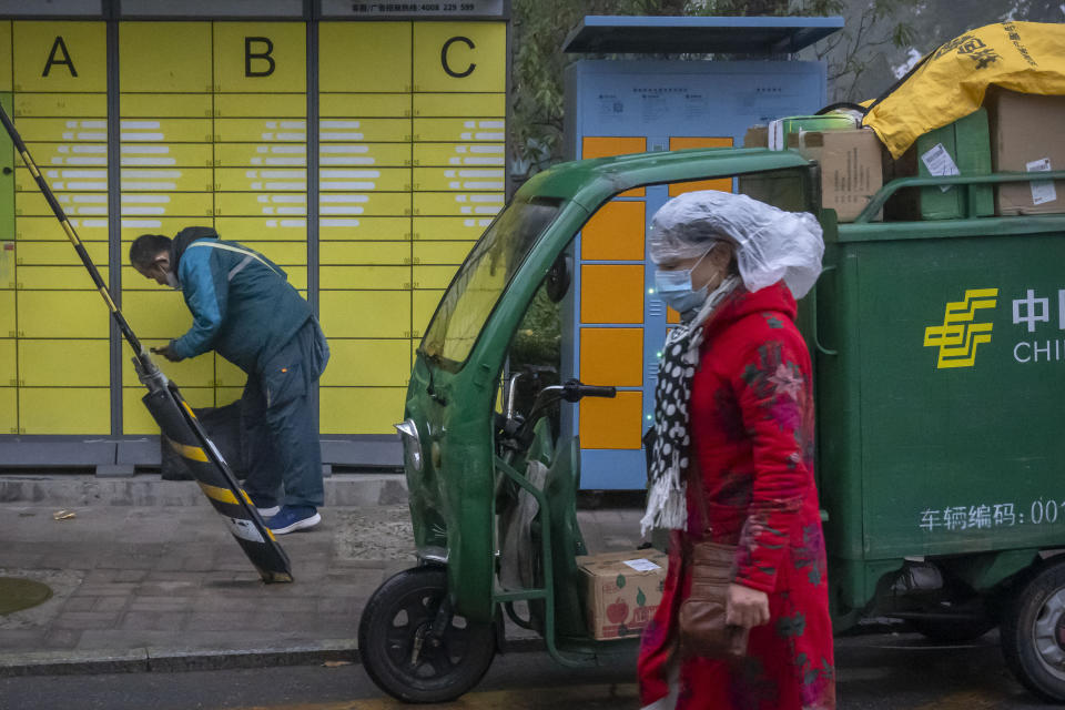 A delivery courier places a package in a customer storage locker outside a residential community in Beijing, Friday, Nov. 11, 2022. China's biggest online shopping festival, Singles' Day, is muted this year with sales numbers expected to grow slowly amid an uncertain economy and COVID-19. Singles’ Day — also known as Double 11 as it falls on Nov. 11 annually — is closely watched as a barometer of consumption in China. (AP Photo/Mark Schiefelbein)