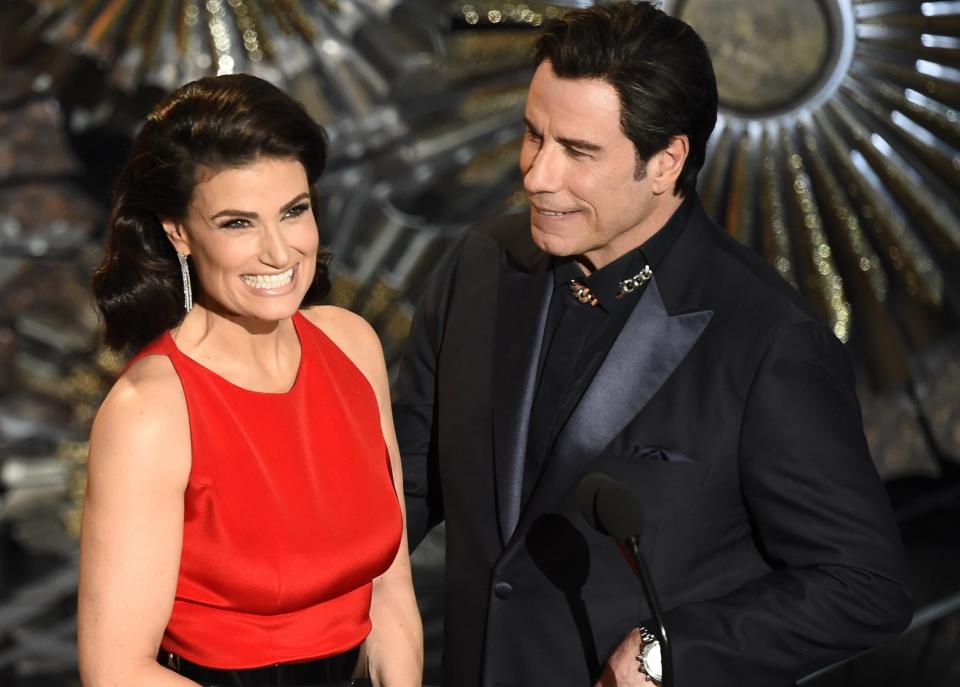Idina and John smile while sharing the stage at a later time