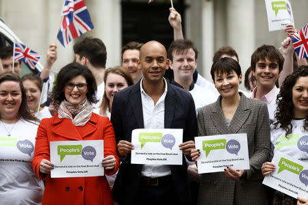 Labour Party MP Chuka Umunna, Liberal Democrat MP Layla Moran and Green MP Caroline Lucas stand with activists as they pose at the launch of the Peoples Vote advertising campaign in central London, Britain April 15, 2018. REUTERS/Simon Dawson