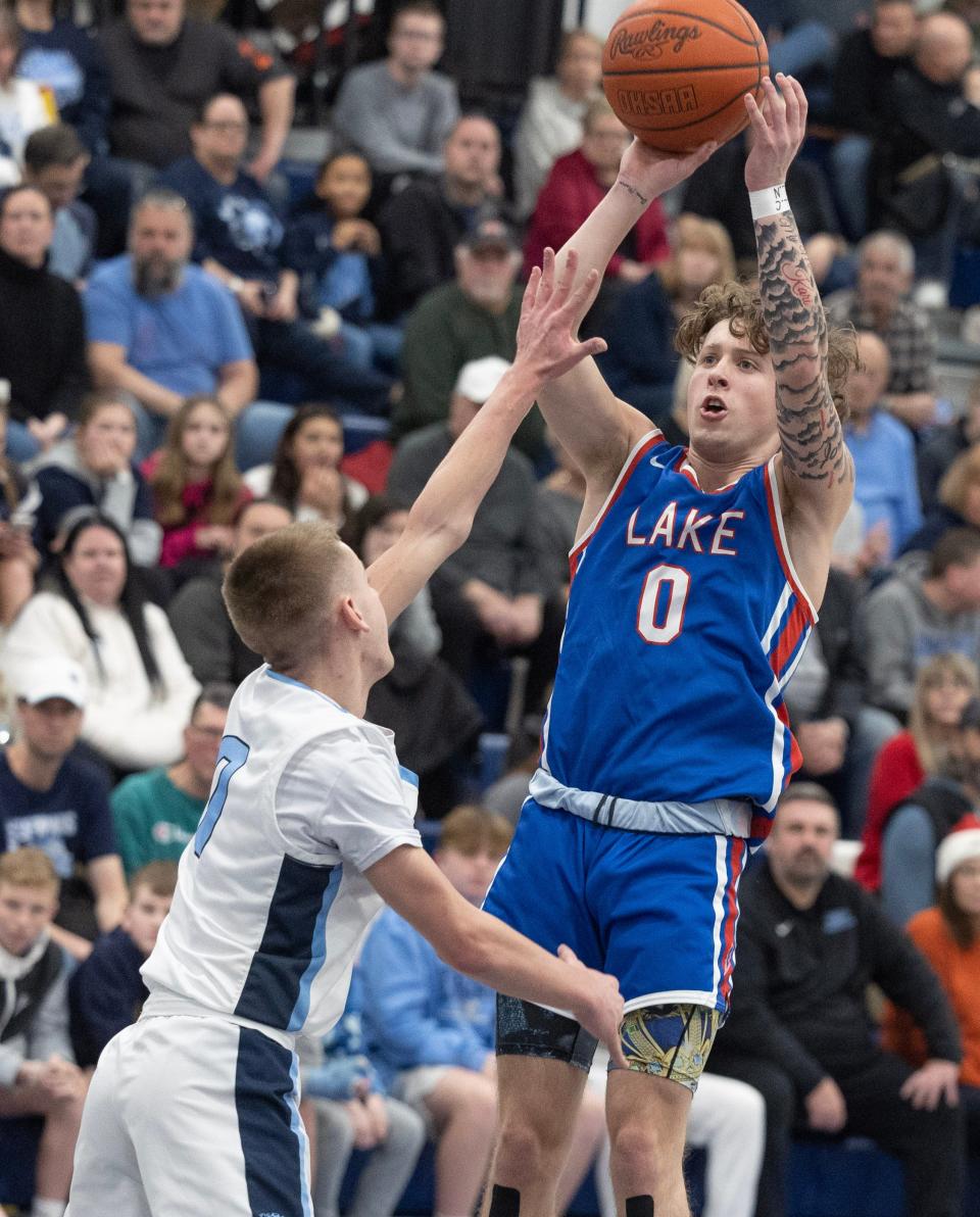 Lake's Chance Casenhiser shoots a 3-pointer over Louisville's Beau Siegfried in the first half, Tuesday, Jan. , 23, 2024.