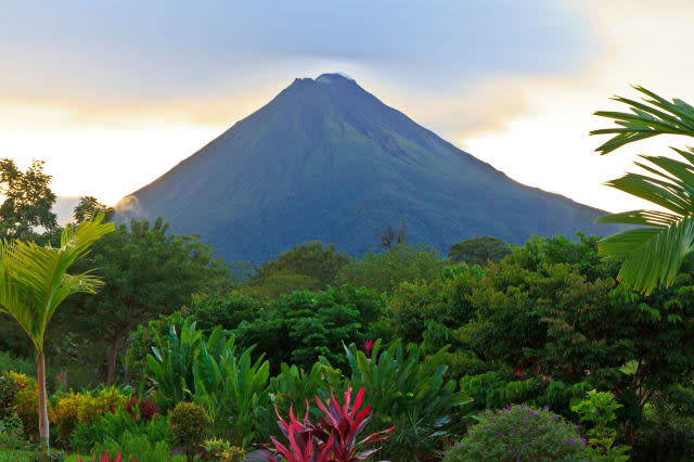 A lush garden in La Fortuna, Costa Rica with Arenal Volcano in the background