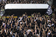 Supporters surround a police bus carrying political activist Edward Leung as it leaves the High Court in Hong Kong, Wednesday, Oct. 9, 2019. Several hundred masked protestors chanting for revolution have gathered at Hong Kong's High Court for the appeal hearing of an activist sentenced to six years in prison for his part in a violent nightlong clash with police. (AP Photo/Vincent Yu)