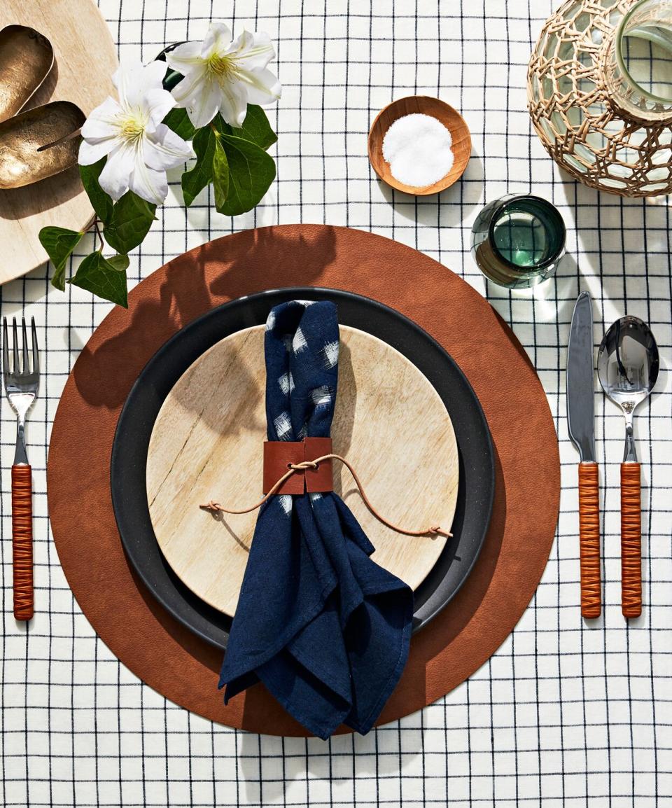 tablescape with grid tablecloth and bamboo and leather serverware