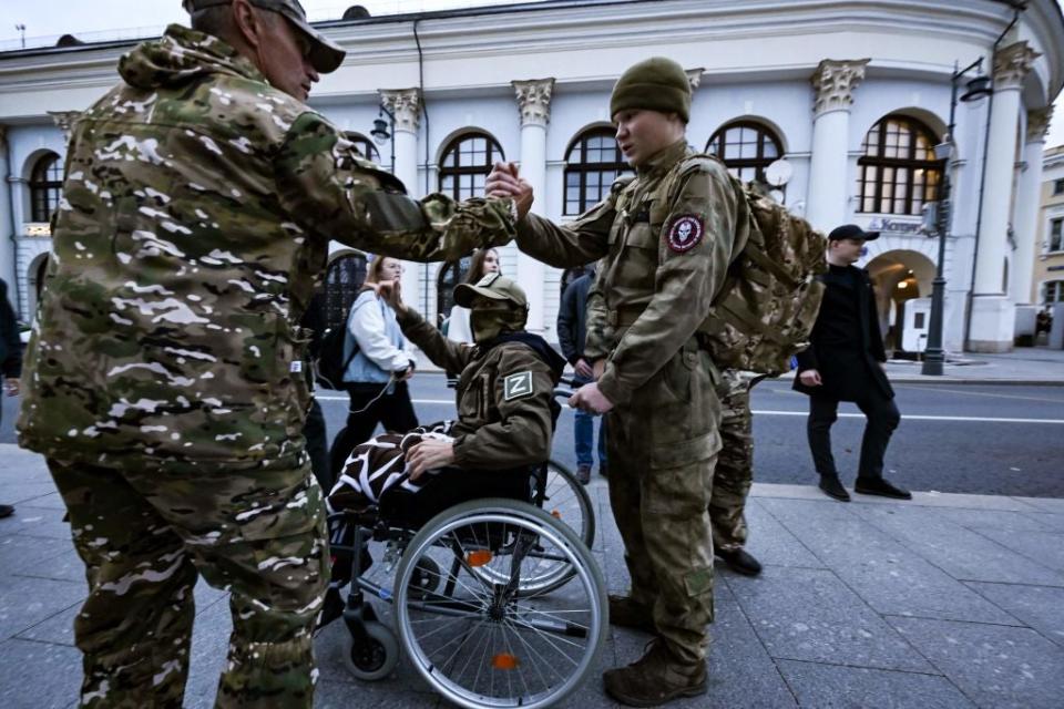 People, including those wearing camouflage uniforms, visit a makeshift memorial for Wagner private mercenary group chief Yevgeny Prigozhin in central Moscow on October 1, 2023, to mark 40 days since his death as per Orthodox tradition. Yevgeny Prigozhin died with nine other people when a plane flying from Moscow to Saint Petersburg crashed on August 23. (Photo by NATALIA KOLESNIKOVA / AFP) (Photo by NATALIA KOLESNIKOVA/AFP via Getty Images)