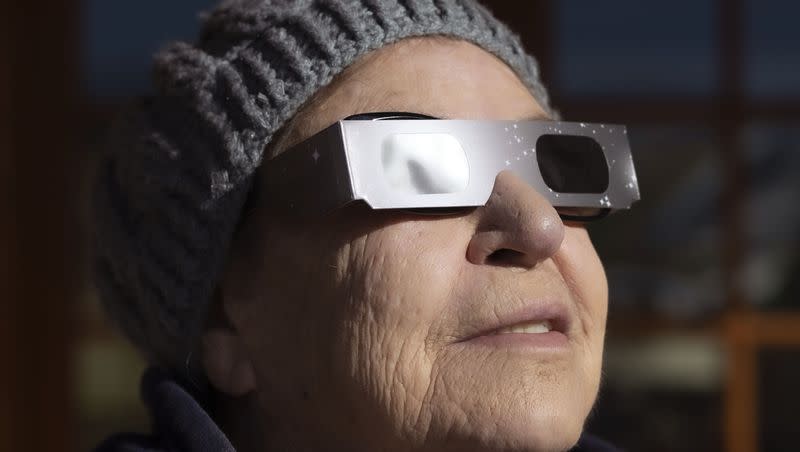 Kathy Henley watches an annular solar eclipse in Torrey, Utah, on Saturday, Oct. 14, 2023. A phenomenon known as the “ring of fire” was visible because of the way the sun’s edges perfectly surround the moon.