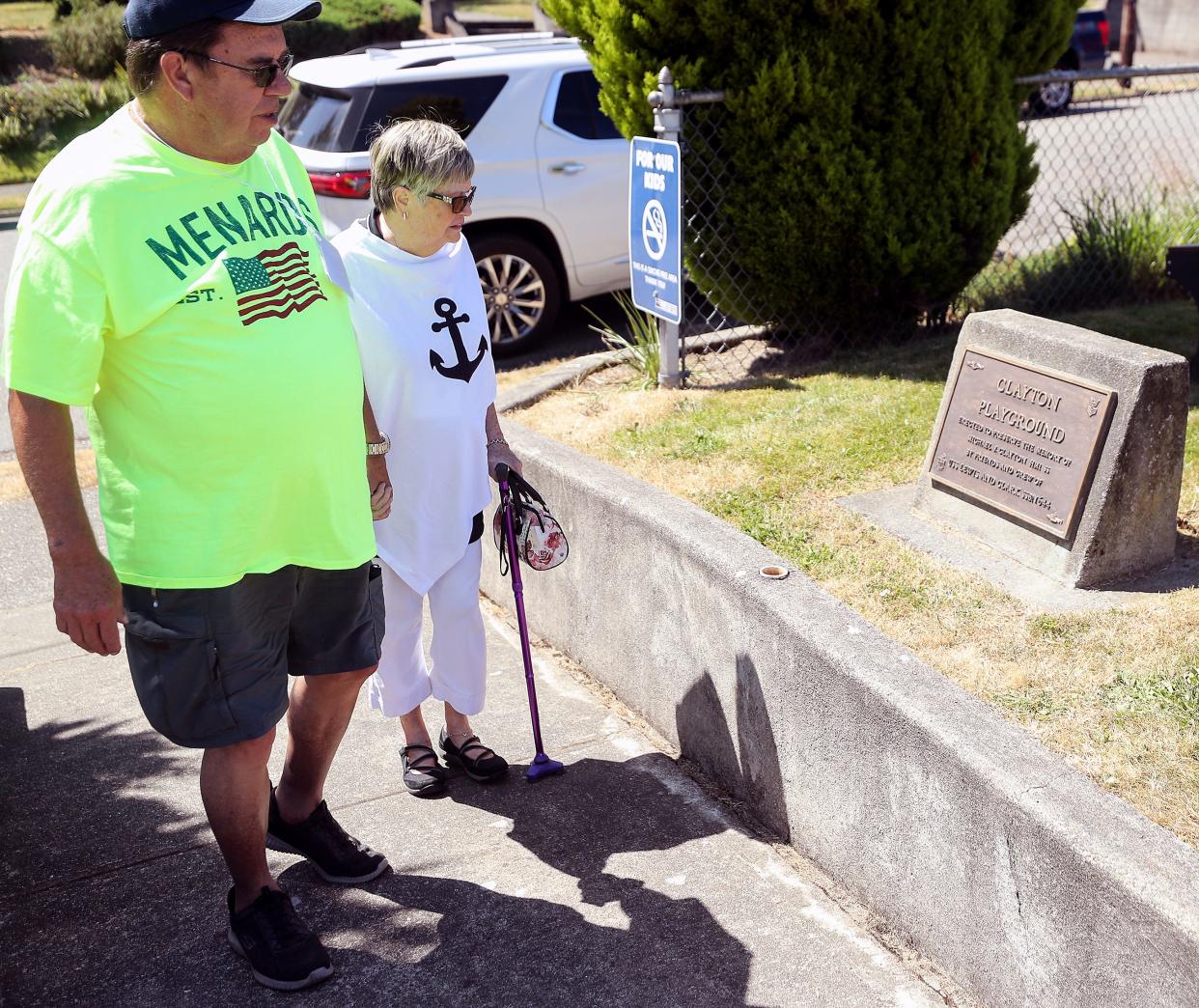 Thom Theele and Merrily LeVee pause to look at the memorial plaque dedicating Port Orchard's Clayton Playground to USS Lewis and Clark submariner Michael Clayton, as the Florida couple arrives to take part in a reunion of the crew on Thursday.