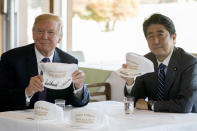 <p>President Donald Trump and Japanese Prime Minister Shinzo Abe hold up hats they have both signed that read “Donald and Shinzo, Make Alliance Even Greater” at Kasumigaseki Country Club, Sunday, Nov. 5, 2017, in Kawagoe, Japan. (Photo: Andrew Harnik/AP) </p>