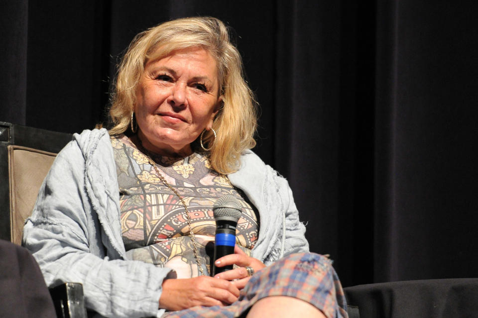 Roseanne Barr holding the mic at an event