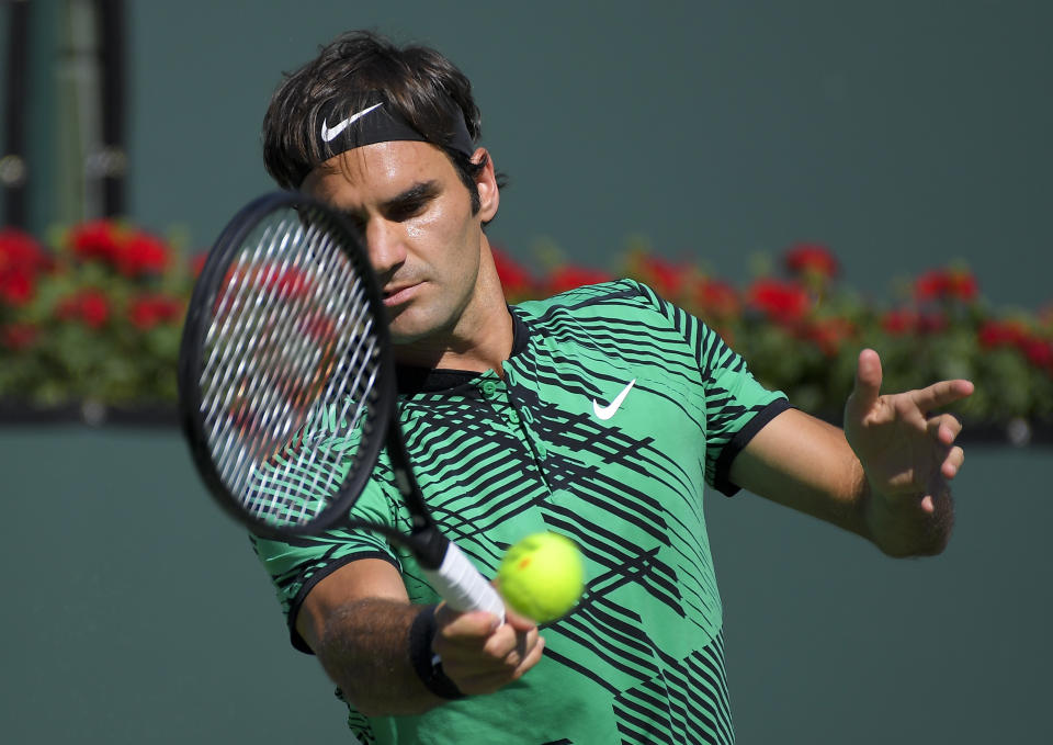 Roger Federer, of Switzerland, hits to Stan Wawrinka, of Switzerland, during the men's final at the BNP Paribas Open tennis tournament, Sunday, March 19, 2017, in Indian Wells, Calif. (AP Photo/Mark J. Terrill)