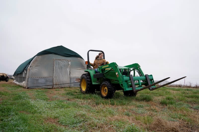 Ward tows a chicken house to a new piece of pasture on her farm in Pawnee