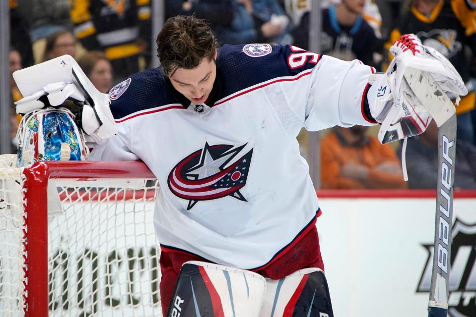 Columbus Blue Jackets goaltender Elvis Merzlikins collects himself during the second period of an NHL hockey game against the Pittsburgh Penguins in Pittsburgh, Friday, April 29, 2022. (AP Photo/Gene J. Puskar)