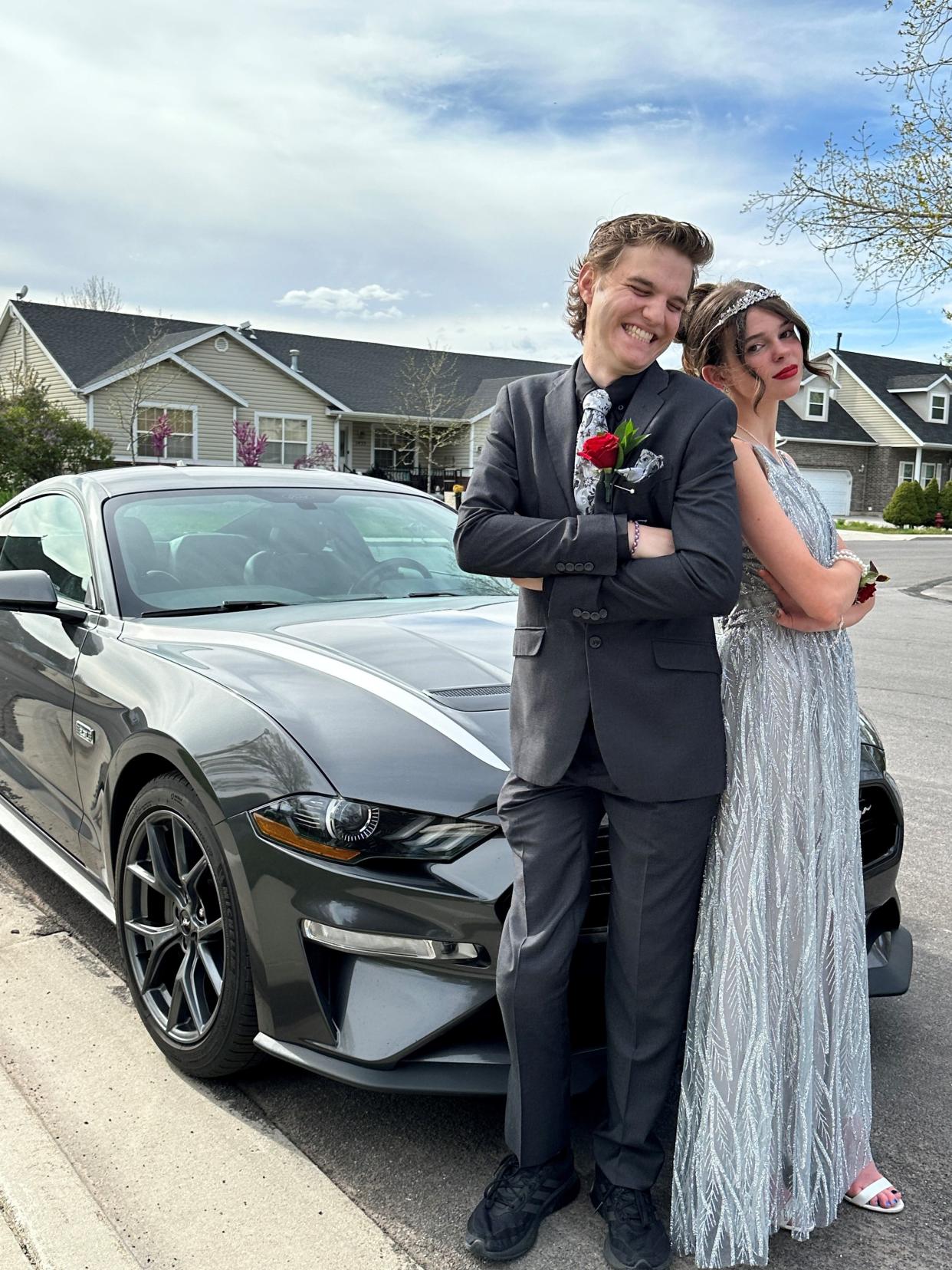 Joseph Tegerdine and Lily Flake, just before prom at Mapleton High School in Utah in April 2024, stand with his 2020 Ford Mustang. He is fighting cancer with just months to live. She reminds him he's still a teenager, he said.