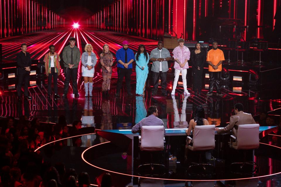 Ryan Seacrest (left) stands with Quintavious, Jordan Anthony, Kennedy Reid, Jennifer Jeffries, Ajii, Nya, Odell Bunton Jr., Mackenzie Sol, Jayna Elise and Roman Collins as the judges decide which four contestants to let into the Top 14.