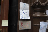 Messages are displayed at the entrance of the Villa Rosa Tablao flamenco venue during a protest in Madrid, Spain, Thursday March 4, 2021. The National Association of Tablaos protested outside the mythical Villa Rosa Tablao which has been forced to close permanently due to the covid pandemic. Messages in Spanish read ' Goodbye Villa Rose, RIP Flamenco and How sad another Tablao has to close'. (AP Photo/Paul White)