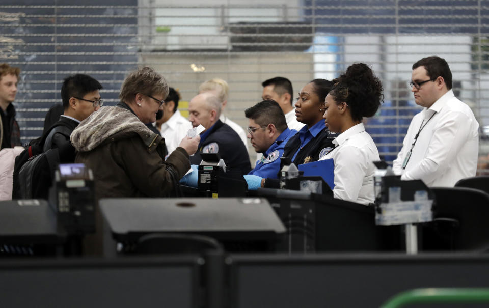 Transportation Security Administration officers work at a checkpoint at O'Hare airport in Chicago, Friday, Jan. 11, 2019, as the partial government shutdown continues. (AP Photo/Nam Y. Huh)