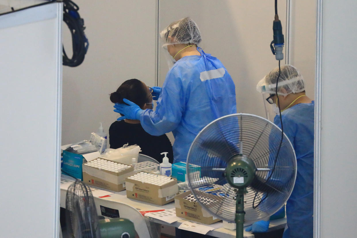 A healthcare worker administers a swab test at a temporarily COVID-19 testing centre in Singapore.