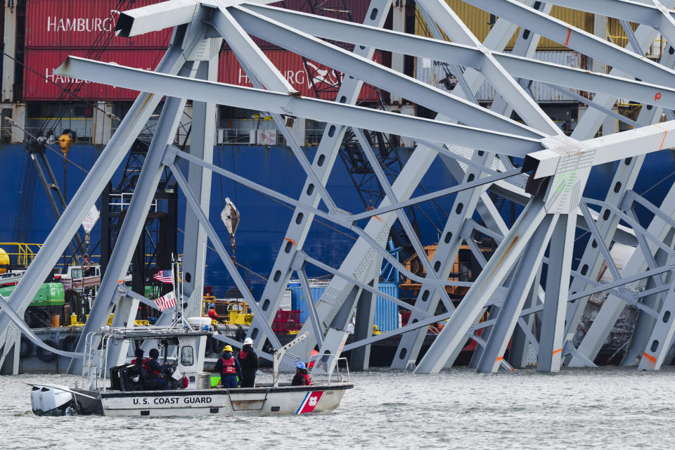 A Coast Guard vessel passes the collapsed Francis Scott Key Bridge, Thursday, April 25, 2024, in Baltimore. (AP Photo/Matt Rourke)