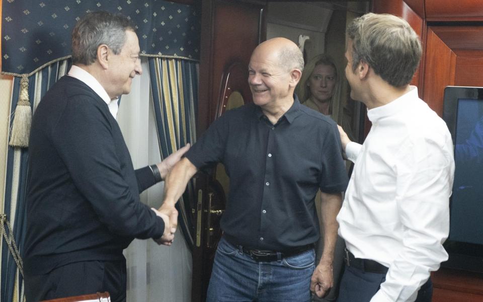 A handout photo made available by the Italian Government's Press Office shows Italian Prime Minister Mario Draghi, left, German Chancellor Olaf Scholz and French President Emmanuel Macron greeting each other inside a train carriage at an undisclosed location on their way from Poland to Kyiv, Ukraine - Filippo Attili HANDOUT/EPA-EFE/Shutterstock