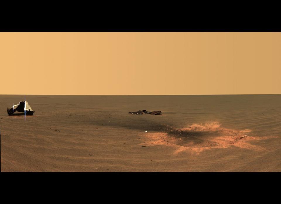 Postcard of the crater created after the Opportunity rover's heat shield was jettisoned during the January 24, 2004 landing. This is the youngest (known) impact crater on Mars.      <em>Opportunity Pancam mosaic, mission sol 330 (December 28, 2004).  From "Postcards from Mars" by Jim Bell; Photo credit: NASA/JPL/Cornell University  </em>