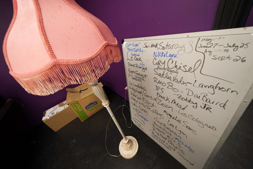 A board with names of music acts sits in a room with other items to be put back in place as work is done to rebuild The Basement East, a live music venue, Feb. 25, 2021, in Nashville, Tenn. The building was destroyed by a tornado March 3, 2020, and the difficulties of reopening were compounded by COVID-19. Now, as the anniversary of the two catastrophic events approaches, the owners hope to reopen their doors, this time with masks and tables spread out throughout their 5,000 square foot space. (AP Photo/Mark Humphrey)