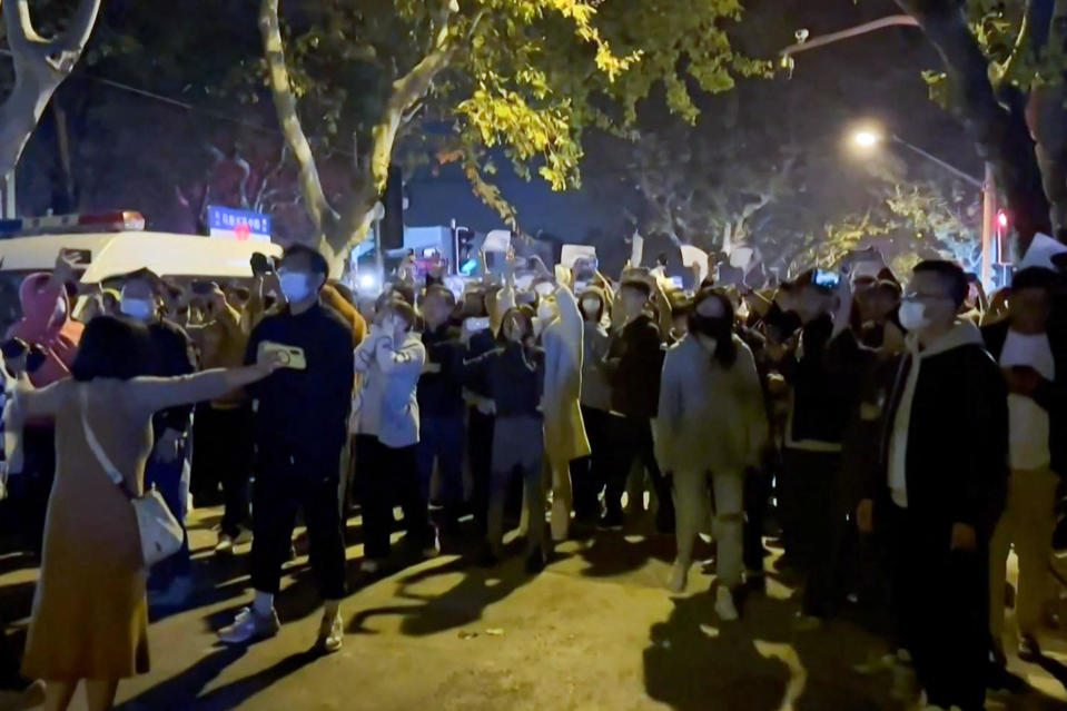 This frame grab from eyewitness video footage made available via AFPTV on November 27, 2022 shows demonstrators shouting slogans in Shanghai.  / Credit: AFPTV/AFP via Getty Images