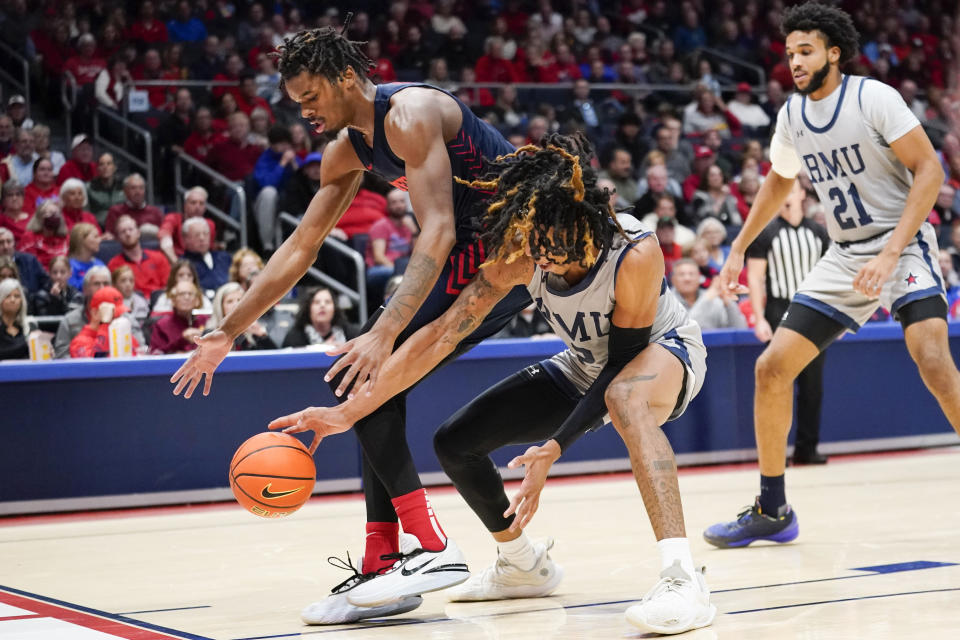 Dayton forward DaRon Holmes II, left, and Robert Morris forward Kahliel Spear, right, fight for a loose ball near the baseline during the second half of an NCAA college basketball game, Saturday, Nov. 19, 2022, in Dayton, Ohio. (AP Photo/Joshua A. Bickel)