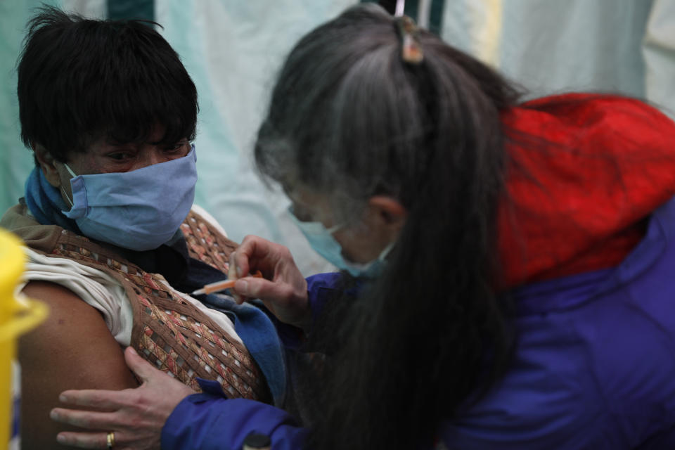 Dr Jacqueline Marshall with her patient Margaret Duncan Williams as she gives her a dose of the AstraZeneca Covid-19 vaccine during the pilot project of pop up vaccination drive 'Vaxi Taxi' in Kilburn, London, Sunday, Feb. 28, 2021. The pilot scheme, funded by the Covid Crisis Rescue Foundation, aims to help ferry supplies and patients to temporary clinics set up in faith and community centres across the capital. People don’t even need to leave the backseat if they didn’t want to in order to receive their inoculation. (AP Photo/Alastair Grant)