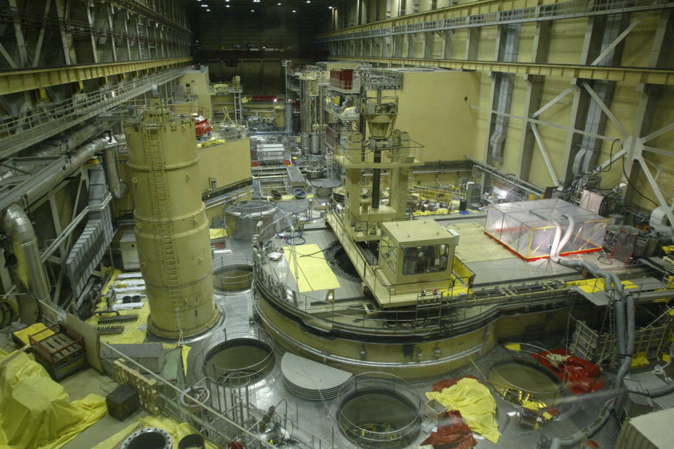 FILE - A plastic tent, right, covers a cleaning apparatus in Reactor Block 2 of the Paks Nuclear Power Plant to catch a small amount of still leaking radioactive gas in Paks, Hungary, about 90 kilometers (56 miles) south of Budapest on Tuesday, April 22, 2003. Hungary, which maintains close ties to Russia, is fully dependent on Moscow to provide fuel for its four-reactor nuclear power plant. (Tibor Illyes/MTI via AP, File)