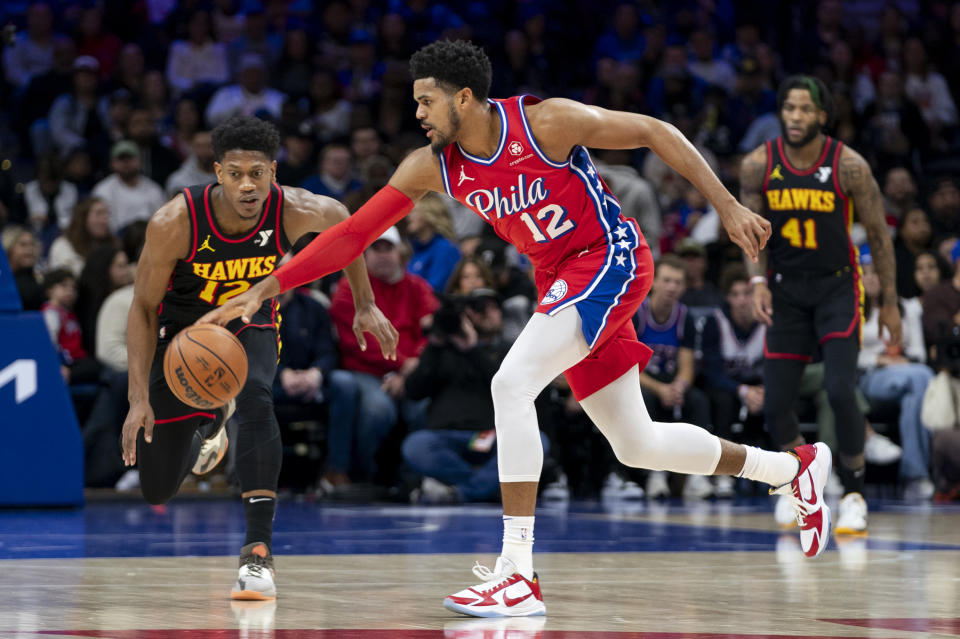 Philadelphia 76ers' Tobias Harris, right, reaches for the ball before Atlanta Hawks' De'Andre Hunter could get to it during the first half of an NBA basketball game Friday, Dec. 8, 2023, in Philadelphia. (AP Photo/Chris Szagola)