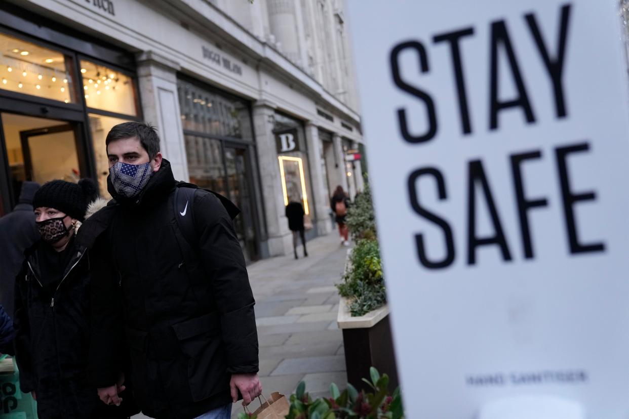 Pedestrians wearing face masks against the coronavirus walk along Regent Street in London. The emergence of the new COVID-19 omicron variant and the world's desperate and likely futile attempts to keep it at bay are reminders of what scientists have warned for months: The coronavirus will thrive as long as vast parts of the world lack vaccines.