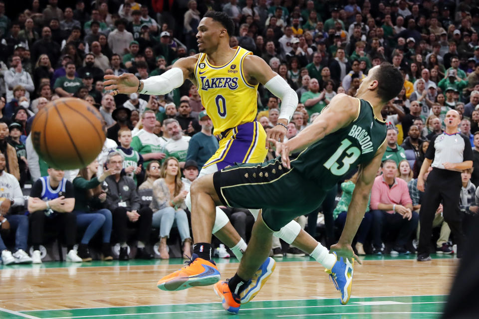 Boston Celtics' Malcolm Brogdon (13) commits a flagrant foul on Los Angeles Lakers' Russell Westbrook (0) during overtime in an NBA basketball game Saturday, Jan. 28, 2023, in Boston. (AP Photo/Michael Dwyer)