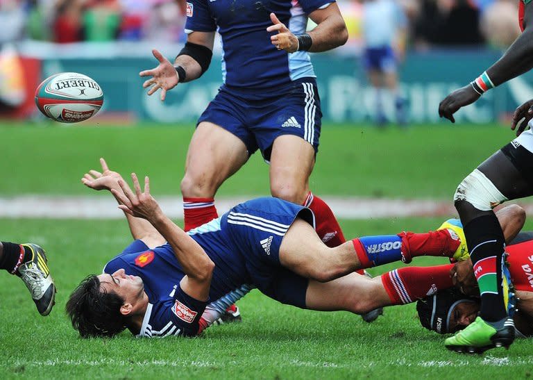 Kenya's Biko Adema (bottom-R) tackles France's Paul Albaladejo (bottom-C) during the Hong Kong Rugby Sevens tournament, on March 23, 2013. With Sevens making its debut as an Olympic sport in Rio in 2016, coaches and players across the world are setting their sights on a place at the next Games