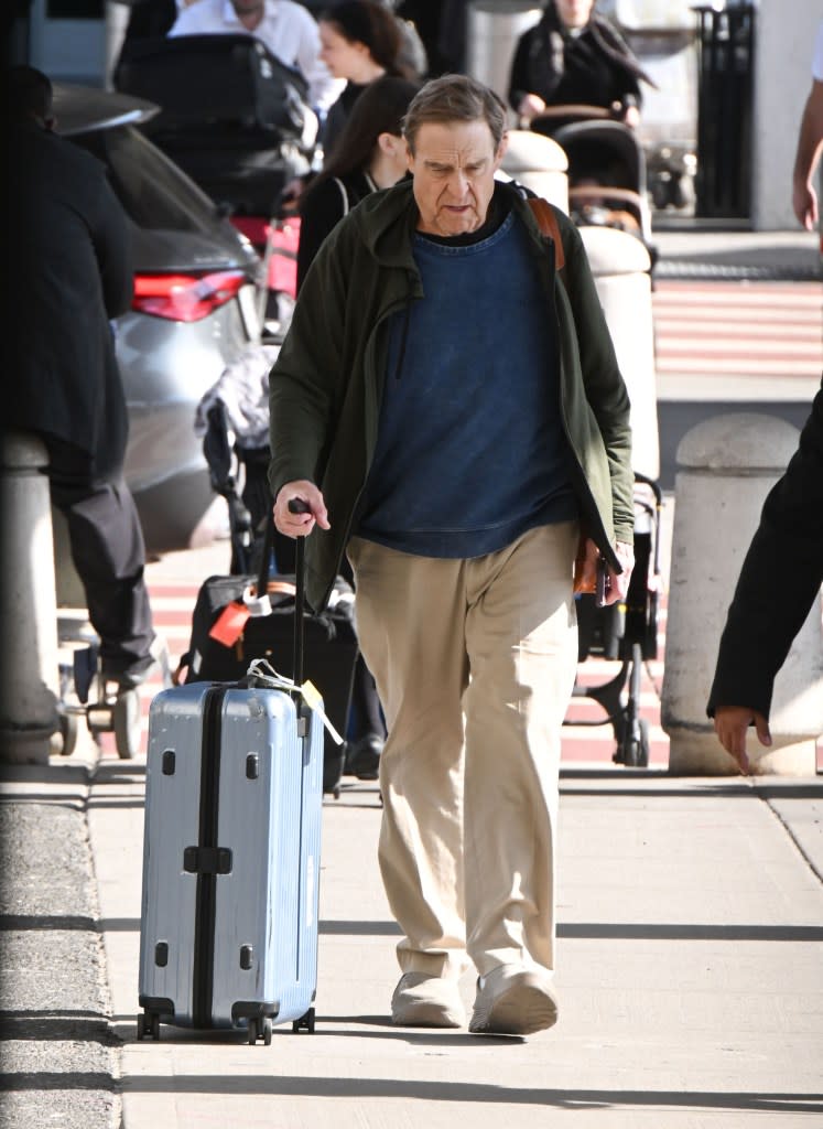 In those photos, Goodman can be seen wearing the same blue sweater and green jacket but instead of jeans, the “10 Cloverfield Lane” star opted to wear a pair of khaki pants. TheImageDirect.com