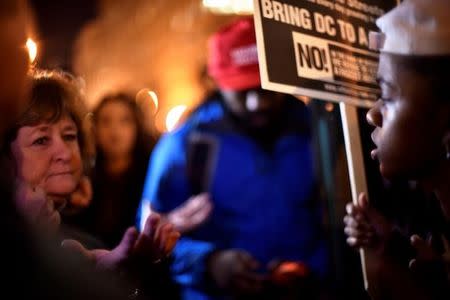 A demonstrator against U.S. president-elect Donald Trump (R) clashes with a Trump supporter (L) in Washington, U.S., January 19, 2017. REUTERS/James Lawler Duggan