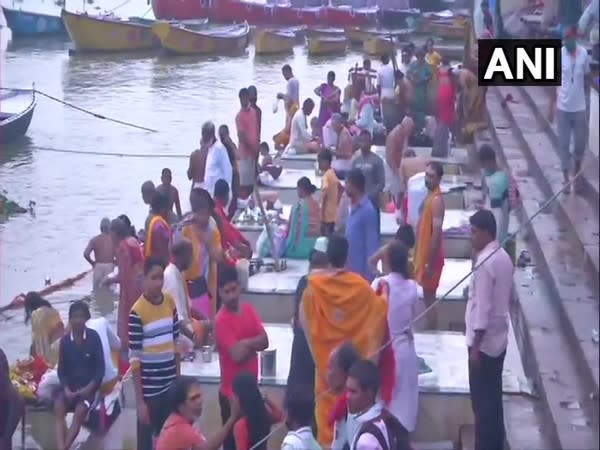 Devotees assemble at the Ganga ghat on the occasion of Ganga Dussehra in Varanasi on Sunday. [Photo/ANI]