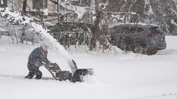 PHOTO: A person tries to use a snowblower to clear snow from their driveway, over a foot deep, during a noreaster in Rutland, Massachusetts on March 14, 2023. (Joseph Prezioso/AFP via Getty Images)