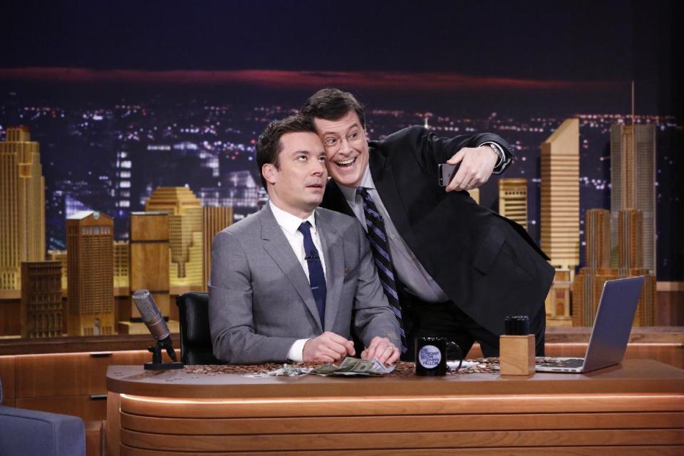 In this photo provided by NBC, Jimmy Fallon appears with Stephen Colbert, right, during his "The Tonight Show" debut on Monday, Feb. 17, 2014, in New York. Fallon departed from the network's “Late Night” on Feb. 7, 2014, after five years as host, and is now the host of “The Tonight Show,” replacing Jay Leno after 22 years. (AP Photo/NBC, Lloyd Bishop)