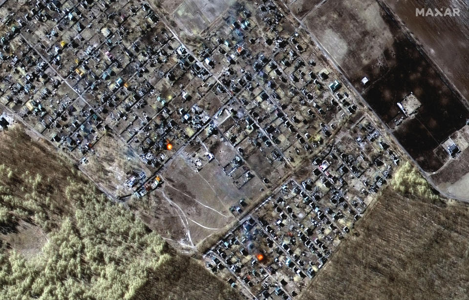This multispectral satellite image provided by Maxar Technologies shows destroyed homes, impact craters and fires in town of Moschun, Ukraine, during the Russian invasion, Friday, March 11, 2022. (Satellite image ©2022 Maxar Technologies via AP)