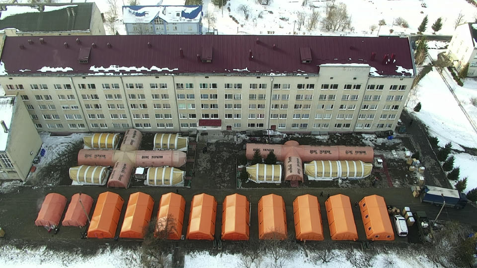 In this photo released by Ukraine's Emergency Situation Ministry on Feb. 20, 2021, a mobile hospital is set up in front of a regional hospital in the Ivano-Frankivsk region, Ukraine. After several delays, Ukraine finally on Tuesday, Feb. 23, 2021, received 500,000 doses of the AstraZeneca vaccine marketed under the name CoviShield, the first shipment of Covid-19 vaccine doses. The country of 40 million is one of the last in the region to begin inoculating its population. (Emergency Situation Ministry via AP)