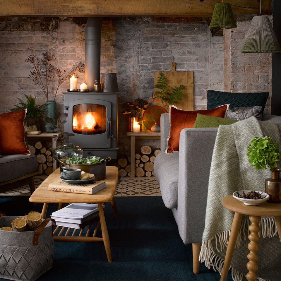 <p> A cosy fireside setting instantly becomes the focal point of a rustic living room ideas. For a traditional feel make all your decor choices focus around the living room fireplace ideas. A blazing log burner instantly makes the room feel warm and inviting with furniture arranged centrally around it. </p> <p> Rich, earthy colours feel naturally at home for this look, so try a warm, russet red on the walls to set the mood. Expose original brickwork and treat wooden beams to restore them to natural glory. Team original surfaces with textured linens, chunky knits and accents of copper and burnished orange on sumptuous fabric choices. </p>