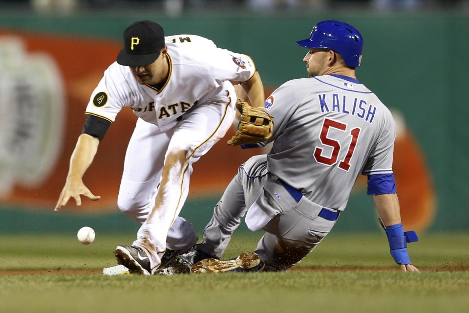 Pittsburgh Pirates shortstop Jordy Mercer, left, drops the ball and Chicago Cubs' Ryan Kalish (51) is safe at second on a ground ball by Edwin Jackson in the fifth inning of a baseball game Wednesday, April 2, 2014, in Pittsburgh. A throwing error was ruled on Pirates third baseman Pedro Alvarez. (AP Photo/Keith Srakocic)