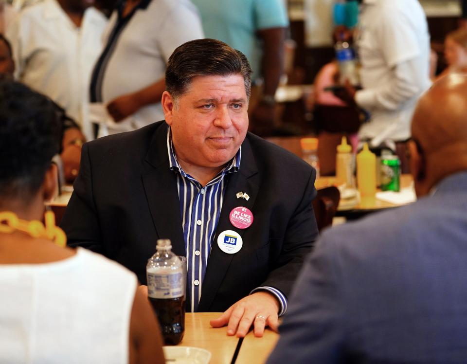 File: Governor JB Pritzker talks with supporters at Manny’s Deli in Chicago, Tuesday, 28 June 2022 (AP)