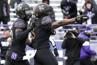 Northwestern wide receiver A.J. Henning, right, right, celebrates with wide receiver Calvin Johnson II., after catching a pass against Maryland during the second half of an NCAA college football game, Saturday, Oct. 28, 2023, in Evanston, Ill. Northwestern won 33-27. (AP Photo/Nam Y. Huh)