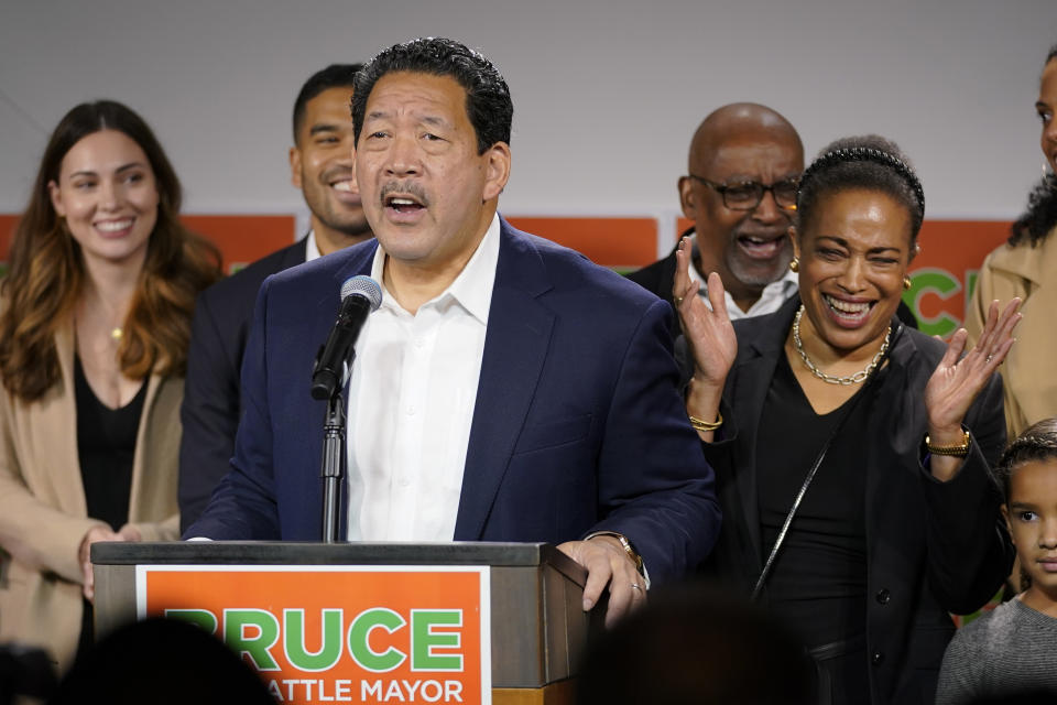 Bruce Harrell, who is running against Lorena Gonzalez in the race for mayor of Seattle, speaks to supporters as his wife, Joanne Harrell, right, applauds, Tuesday, Nov. 2, 2021, in Seattle. (AP Photo/Ted S. Warren)