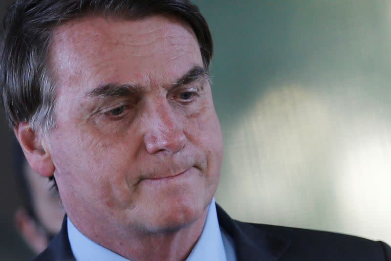 FILE PHOTO: Brazil's President Jair Bolsonaro looks on after a meeting at the Ministry of Defense headquarters, amid the coronavirus disease (COVID-19) outbreak, in Brasilia